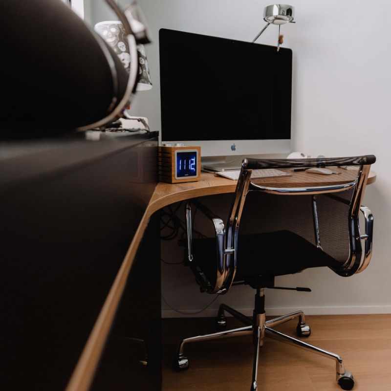 Bureau noir mat avec plateau en bois dans une chambre