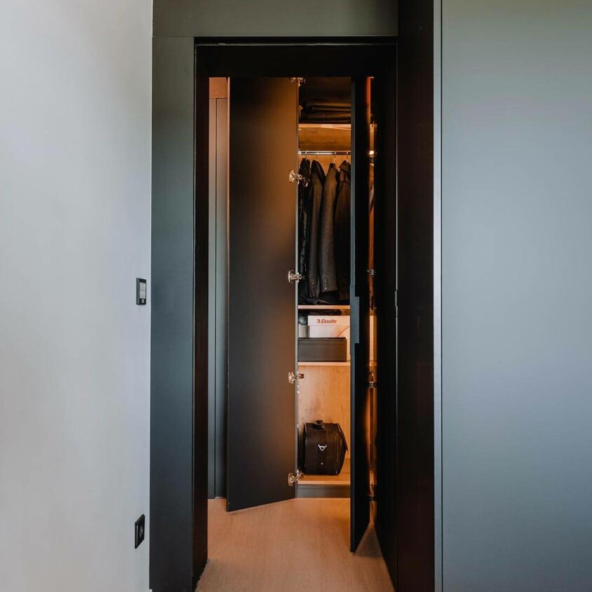 Aménagement global d'un appartement à Luxembourg avec mobilier noir et armoire éclairée
