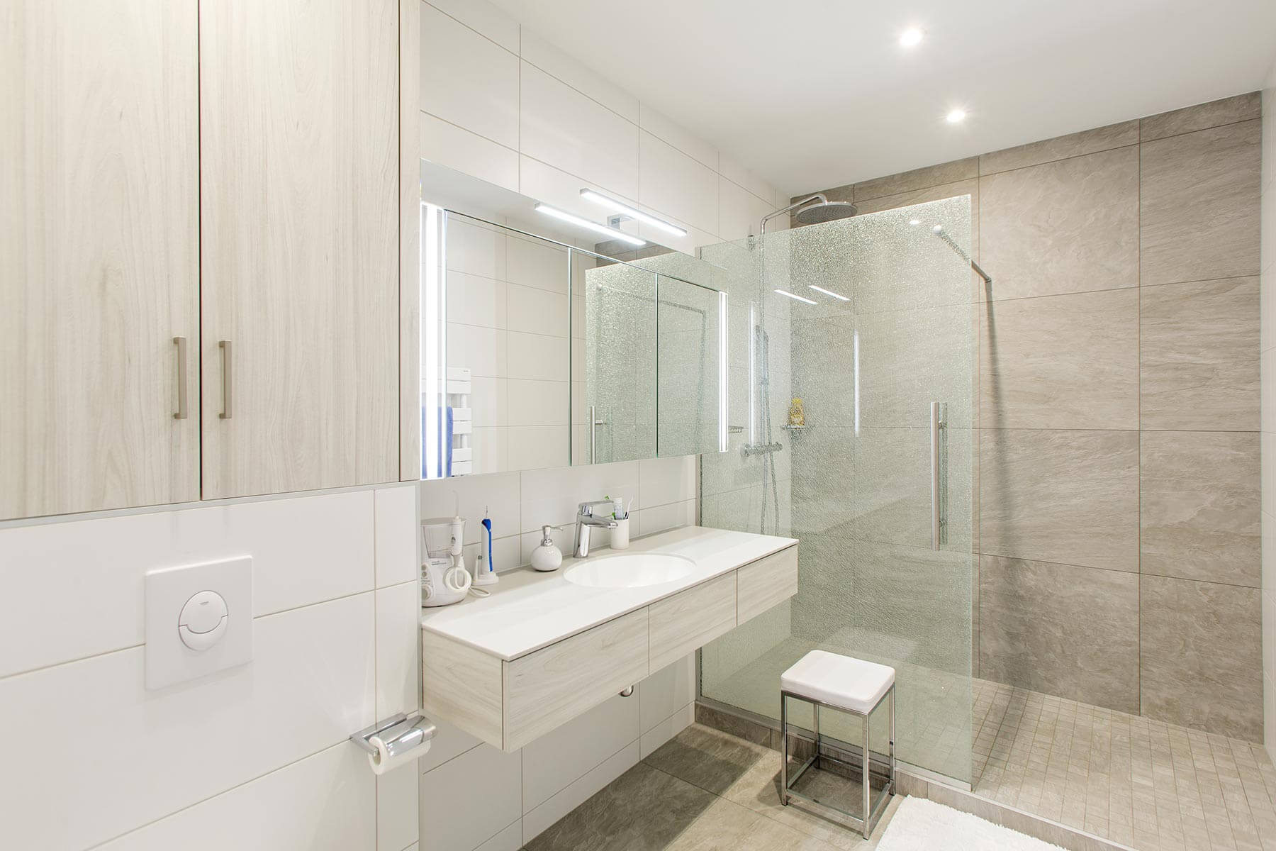 Salle de bain réalisée pour un Aménagement global d'appartement à Genève avec dominantes blanche et beige